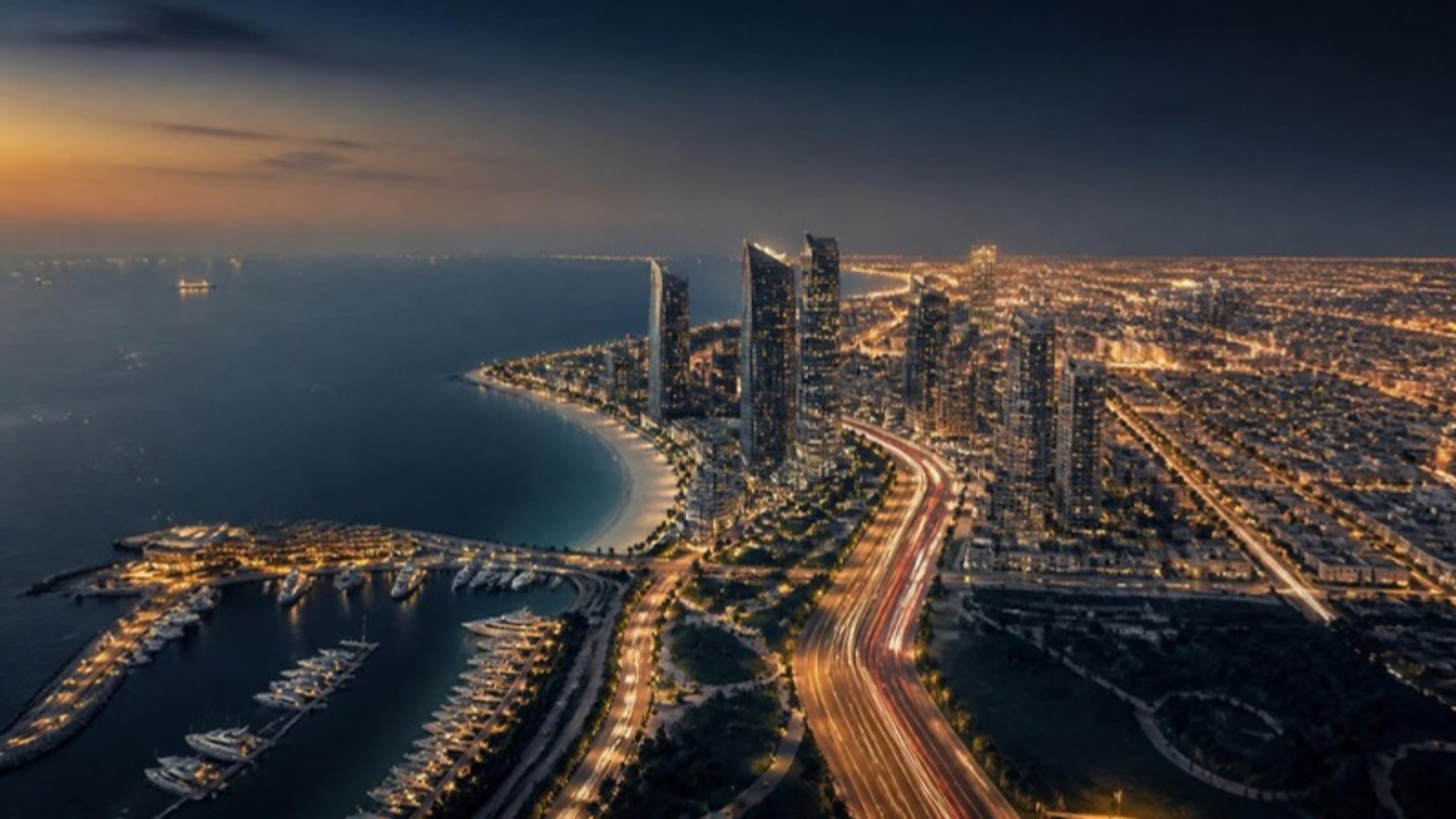 Aerial view of a coastal Gulf city at dusk with a marina and highway